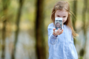 Let your kids take their own selfies and you can accumulate a large number of portraits hands-free